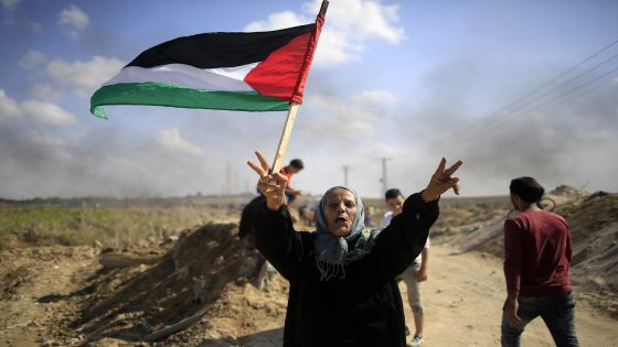 امرأة مصرية تحمل علم فلسطين وسط القاهرة